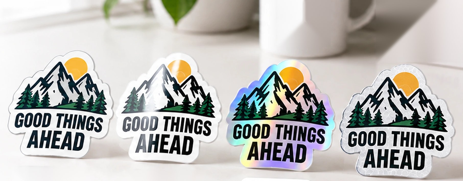 The same die-cut sticker in four finishes: matte vinyl, gloss vinyl, holographic and reflective